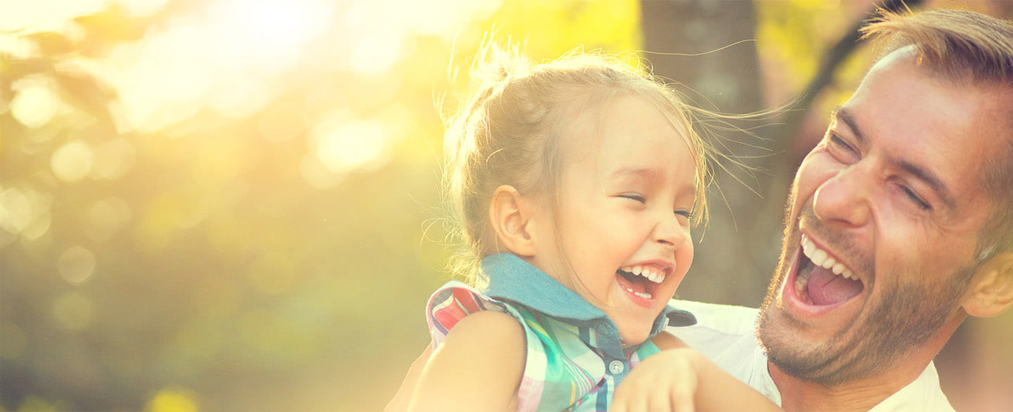 Dad and daughter laughing.